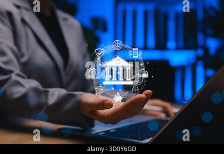 Concept de banque numérique. Homme d'affaires détenant l'icône de banque numérique représentant la technologie financière, les services bancaires mobiles, l'économie mondiale, fintech Banque D'Images