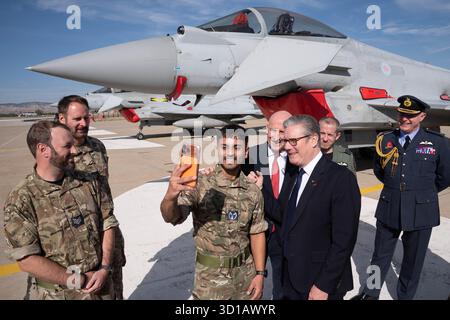 Le premier ministre Sir Keir Starmer (à droite) et le secrétaire à la Défense John Healey (au centre à droite) posent pour un selfie avec des membres des forces armées britanniques devant un avion de chasse britannique Typhon à la base aérienne Tusas à Ankara, lors d'une visite en Turquie. Date de la photo : lundi 27 octobre 2025. Banque D'Images