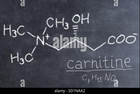 Structure chimique des molécules sur tableau noir. Professeur de sciences ou étudiant en chimie dessinant la formule chimique sur le tableau noir en classe. Nicotine, carnitine, Banque D'Images