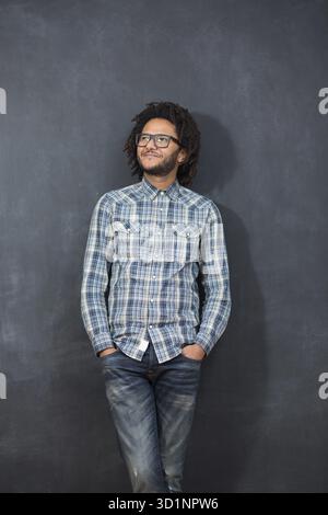 Jeune homme afro-américain beau gestuel posingon émotionnel tableau, hipster sur tableau Banque D'Images