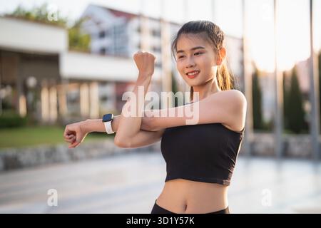 Femme asiatique active en bonne santé exerçant des athlètes dans des vêtements de fitness Sunrise sport Girl devant la motivation de la ville pour un Li sain Banque D'Images