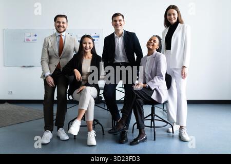 Portrait d'un groupe réussi de gens d'affaires au bureau moderne regardant la caméra. Portrait d'hommes d'affaires heureux et satisfaits Banque D'Images