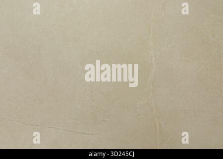 Surface en marbre beige clair avec des veines subtiles et de la texture sous un éclairage lumineux mettant en valeur des motifs naturels et l'élégance dans inter Banque D'Images