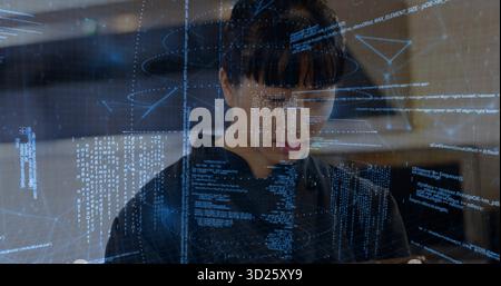 Ingénieur asiatique adulte moyen analysant le code sur l'interface holographique dans le laboratoire technologique, avec tablette portable Banque D'Images