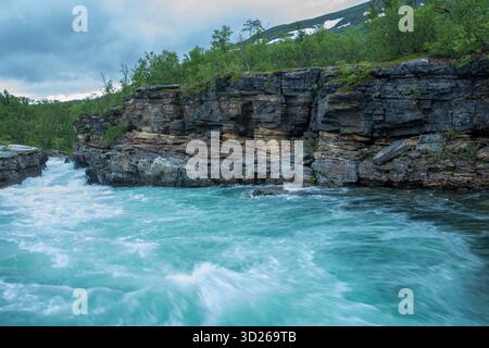 L'eau turquoise de la belle rivière Abisko, Abiskojokk, coule entre les rochers du canyon Abisko, Suède, Europe du Nord Banque D'Images