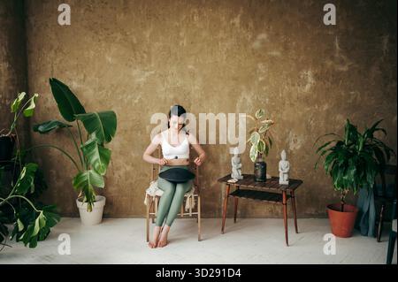 Jeune femme attrayante jouant sur le tambour de réservoir à l'intérieur Banque D'Images