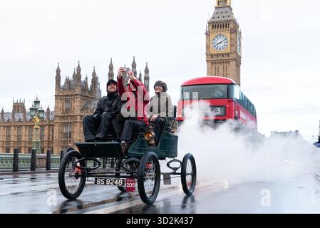 Westminster, Londres, Royaume-Uni. 2 novembre 2025. La course automobile de Londres à Brighton est l'événement automobile le plus long au monde, la première ayant lieu après le changement de la loi qui a permis aux « locomotives légères » de rouler à des vitesses supérieures à 4 km/h. L'adoption de la loi au Parlement a été célébrée par la première course le 14 novembre 1896, avec 30 voitures en route pour Brighton. Environ 400 voitures y participent qui doivent avoir été construites avant 1905. Partant à l'aube humide de Hyde Park, les véhicules traversaient Londres. 1903 Stanley (vapeur) voiture, passant le Parlement, prenant un selfie Banque D'Images