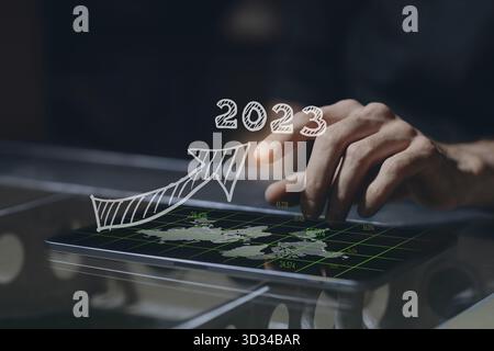 Homme d'affaires main sur tablette PC écran avec flèche graphique de croissance graphique homme d'affaires financier 2023 ans stratégie concept succès modèle de croissance texte Banque D'Images
