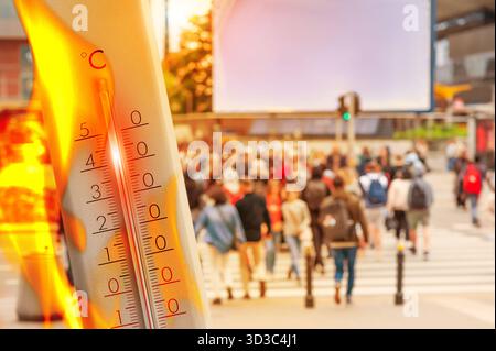 Thermometer showing high temperature against city during hot day Banque D'Images