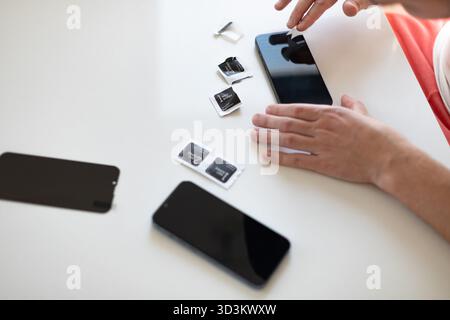Le processus de remplacement d'un verre de protection sur un smartphone. Photo de haute qualité Banque D'Images