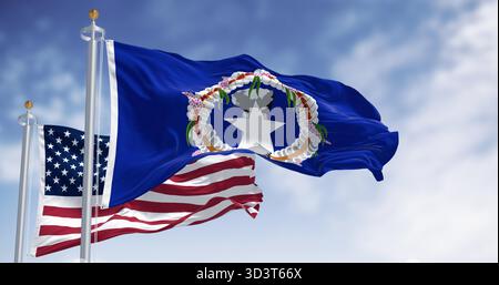 Drapeaux des îles Mariannes du Nord agitant au vent avec le drapeau américain par temps clair. Les îles Mariannes du Nord sont un territoire non incorporé et un commonwealth des États-Unis Banque D'Images