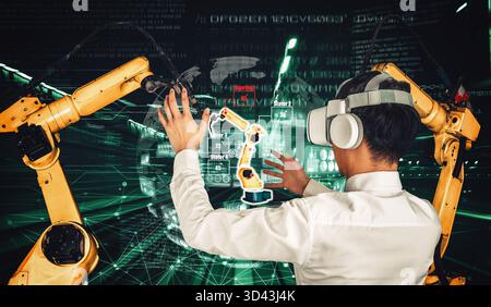 L'ingénieur contrôle les bras robotisés par le logiciel d'application technologique de l'industrie de la réalité augmentée. Robot intelligent dans l'usine future travaillant dans le concept Banque D'Images