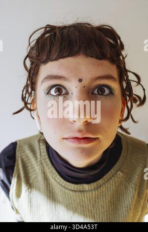 Portrait adolescent mouvement informel, gros plan, avec de petites tresses, avec un dessin à l'encre sur le visage Banque D'Images