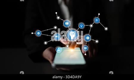 Un professionnel des affaires utilise un smartphone doté d'icônes technologiques et de connexions, symbolisant l'intégration de solutions numériques et artificielles Banque D'Images