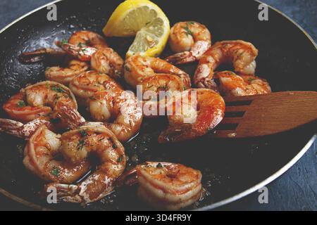 Crevettes tigrées frites, jumbo, dans la sauce à l'ail, dans le beurre, avec des herbes, dans une poêle à frire, fait maison, pas de gens Banque D'Images