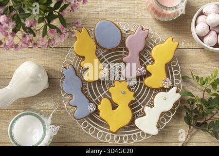 Nourriture, biscuits glacés sucrés et savoureux pour Pâques. Concept de vacances gastronomiques. Pose à plat. Fond en bois, vue de dessus Banque D'Images