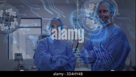 Chirurgiens debout vêtus de robes bleues et masques croisant les bras souriants en salle d'opération avec HUD numérique Banque D'Images