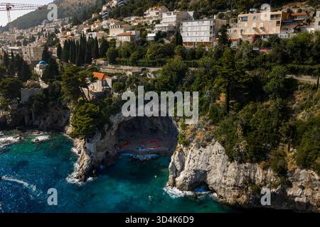 Vue aérienne d'une plage isolée nichée dans une spectaculaire grotte à flanc de falaise, où les eaux turquoise rencontrent la côte accidentée, Dubrovnik, Dubrovnik-Neret Banque D'Images