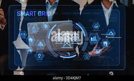 Les professionnels des affaires discutent de la technologie des réseaux intelligents, avec une interface numérique qui met en évidence les aspects clés de l'énergie Banque D'Images