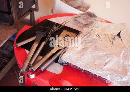 Outil de gril réglé sur fond de gril. Ensemble d'ustensiles de barbecue. Concept de saison barbecue. Griller spatule et autres ustensiles. Préparation de grillades, vue de dessus Banque D'Images