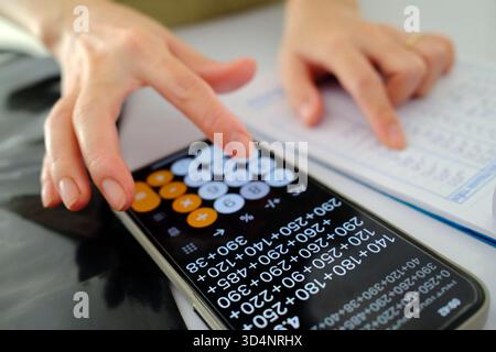 Femme utilisant une calculatrice dans un magasin. Comptabilité. Gros plan sur les mains. Kontum. Vietnam. Banque D'Images