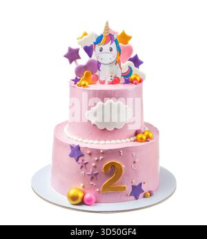 Ce gâteau d'anniversaire festif dispose de deux niveaux ornés d'un topper licorne, d'étoiles colorées et de décorations ludiques, parfait pour la seconde d'un enfant Banque D'Images