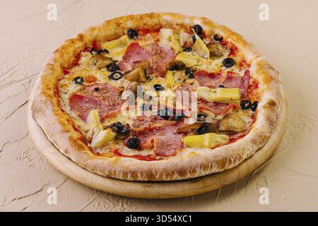 Nourriture, pizza suprême fraîchement cuite garnie de divers ingrédients sur un fond neutre Banque D'Images