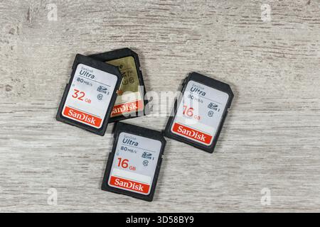 Vue de dessus de plusieurs cartes mémoire SanDisk Ultra SD de différentes capacités sur une surface en bois Banque D'Images
