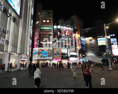 Taipei, Taïwan - 14 novembre 2024 : carrefour animé dans le quartier commerçant de Ximending, rempli de foules, de panneaux d'affichage lumineux et de néons. Banque D'Images