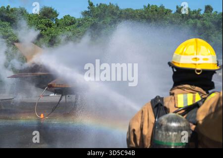 L'aviateur de 1re classe de l'US Air Force Luke Hershberger, pompier des services d'incendie et d'urgence du 18e civil Engineer Squadron, réagit à un aéronef simulé Banque D'Images