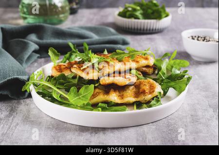 Salade chaude avec halloumi grillé et roquette sur une assiette sur la table Banque D'Images