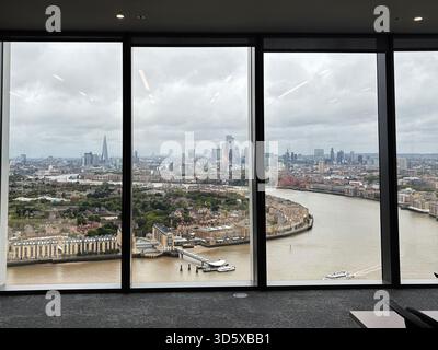 Londres, Royaume-Uni - 22 septembre 2025 : vue spectaculaire sur la ligne d'horizon londonienne et la Tamise depuis une fenêtre de bureau contemporaine. Banque D'Images