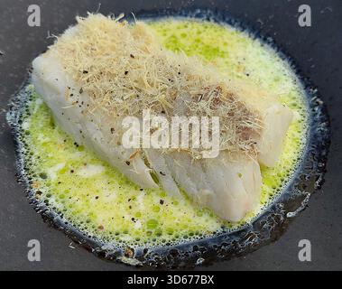 Filet de poisson dans une sauce au beurre et au citron avec de l'ail Banque D'Images