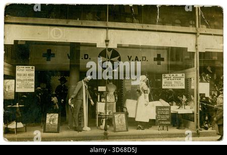 Carte postale originale de l'époque de la première Guerre mondiale représentant une vitrine d'une exposition des services de guerre des femmes au grand magasin Lewis, Bull Street, Birmingham. Il a mis sur une vitrine de magasin - aidant à recruter des VAD non rémunérés pour les hôpitaux auxiliaires dans le district également rémunéré des infirmières stagiaires. Un panneau dans la fenêtre demande 'rejoindre le V.A.D. et aider à soigner les blessés.ce service comprend les sections volontaire et payé'. Mannequins d'infirmières en uniforme et d'un soldat blessé. Une foule de spectateurs / acheteurs se reflète dans la fenêtre. Photographie de Hudson's Studios, Birmingham, Angleterre, Royaume-Uni vers 1915 Banque D'Images
