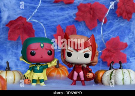 Funko Pop figurines de superhéros Marvel Scarlet Witch Wanda et Vision en costumes d'Halloween. Toile d'araignée, feuilles rouges, citrouilles. Banque D'Images