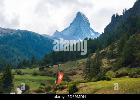Matterhorn dans la vallée suisse verte avec une rivière Gornera qui coule de la montagne avec drapeau suisse à Zermatt, Suisse Banque D'Images