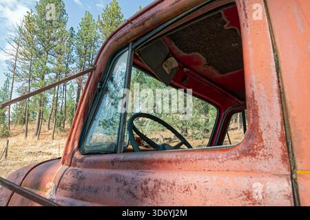 La cabine rouillée d'un camion abandonné avec un trou dans le pare-brise Banque D'Images