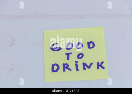 Bon à boire note manuscrite sur papier collant jaune Banque D'Images