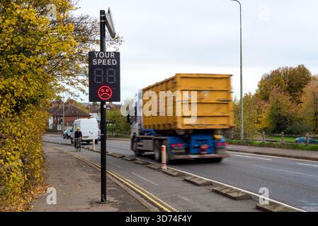 Un camion passant devant un panneau de sensibilisation à la vitesse sur la route britannique Banque D'Images