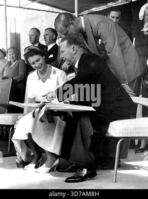 La reine Elizabeth signe un livre à son arrivée à Startford. Avec sa Majesté, M. N. H. Moss, maire de Stratford. 14 janvier 1954. Banque D'Images