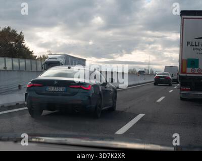 Venise, Italie 21 novembre 2025 véhicules, y compris une BMW série 4 et des camions roulant sur l'Autostrada A4, indiquant l'infrastructure de transport et tr Banque D'Images