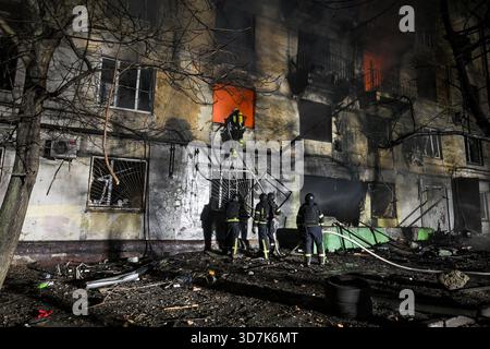 Un pompier monte l’échelle dans un immeuble résidentiel en feu qui a été touché par un drone russe, Zaporizhzhia, Ukraine, le 25 novembre 2025. Mardi soir, le 25 novembre, Zaporizhzhia a été attaqué par des drones russes. La ville a subi d'importants dommages aux infrastructures de logement civil. Plusieurs incendies de grande ampleur ont été signalés. Dix-neuf personnes ont été blessées dans l'attaque. (Photo de Dmytro Smolienko/Ukrinform) Banque D'Images
