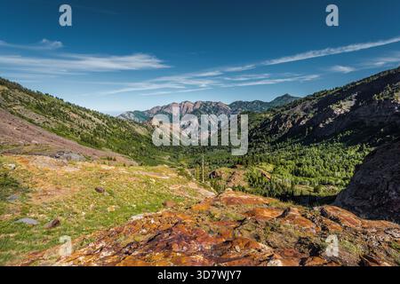 vue panoramique sur la vallée de montagne avec des formations rocheuses orange colorées et des sommets lointains en couches du sentier du lac Blanche de l'Utah Banque D'Images