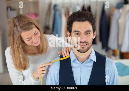 tailleur professionnel prenant des mesures pour costume formel Banque D'Images