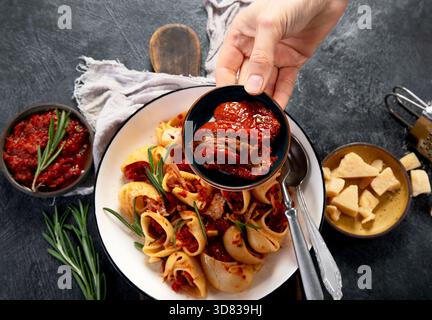 Pasta con Salsa di Pomodori - pâtes à la sauce tomate. Pâtes classiques dans une riche sauce tomate sur fond sombre. Vue de dessus. Banque D'Images