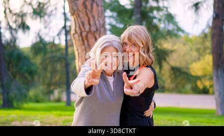 Amis seniors ludiques plaisantant et s'amusant ensemble à l'extérieur Banque D'Images