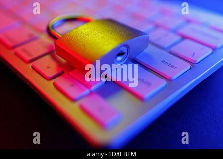 Un cadenas est fixé en toute sécurité sur un clavier, ce qui représente l’importance de la cybersécurité dans la protection des informations sensibles. Cette scène met en lumière measur Banque D'Images