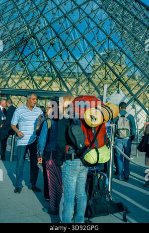 Paris, France – Groupe de personnes, famille de touristes au musée du Louvre, adolescente féminine avec sac à dos, à l'extérieur à l'entrée de la pyramide, voyage à dos de sac pour adolescents Banque D'Images