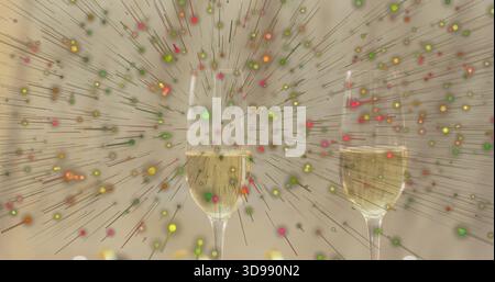 Affichage de flûtes à champagne appariées avec des bulles sur le dessus de table réfléchissant, éclatement de particules colorées Banque D'Images