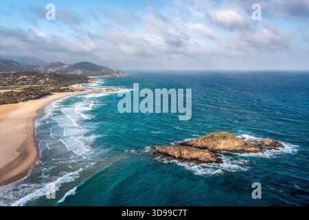 Une vue côtière étendue avec sable doré, eau turquoise et affleurements rocheux, Sardaigne, Italie Banque D'Images